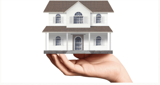 house held on the palm of a hand